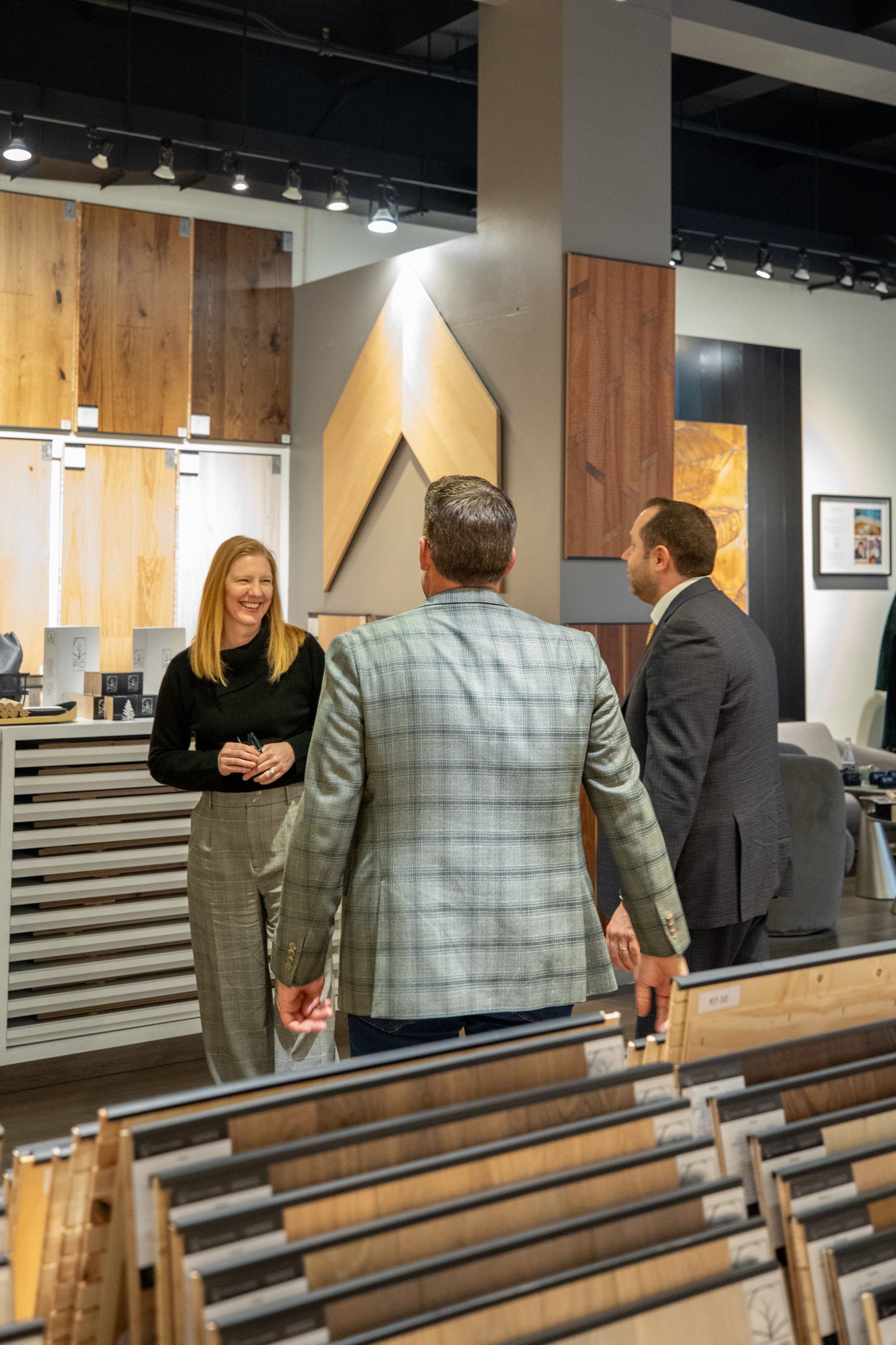 Industry leaders Stephanie Owen and Steven Skutelsky examining European oak flooring at PID Floors NYC