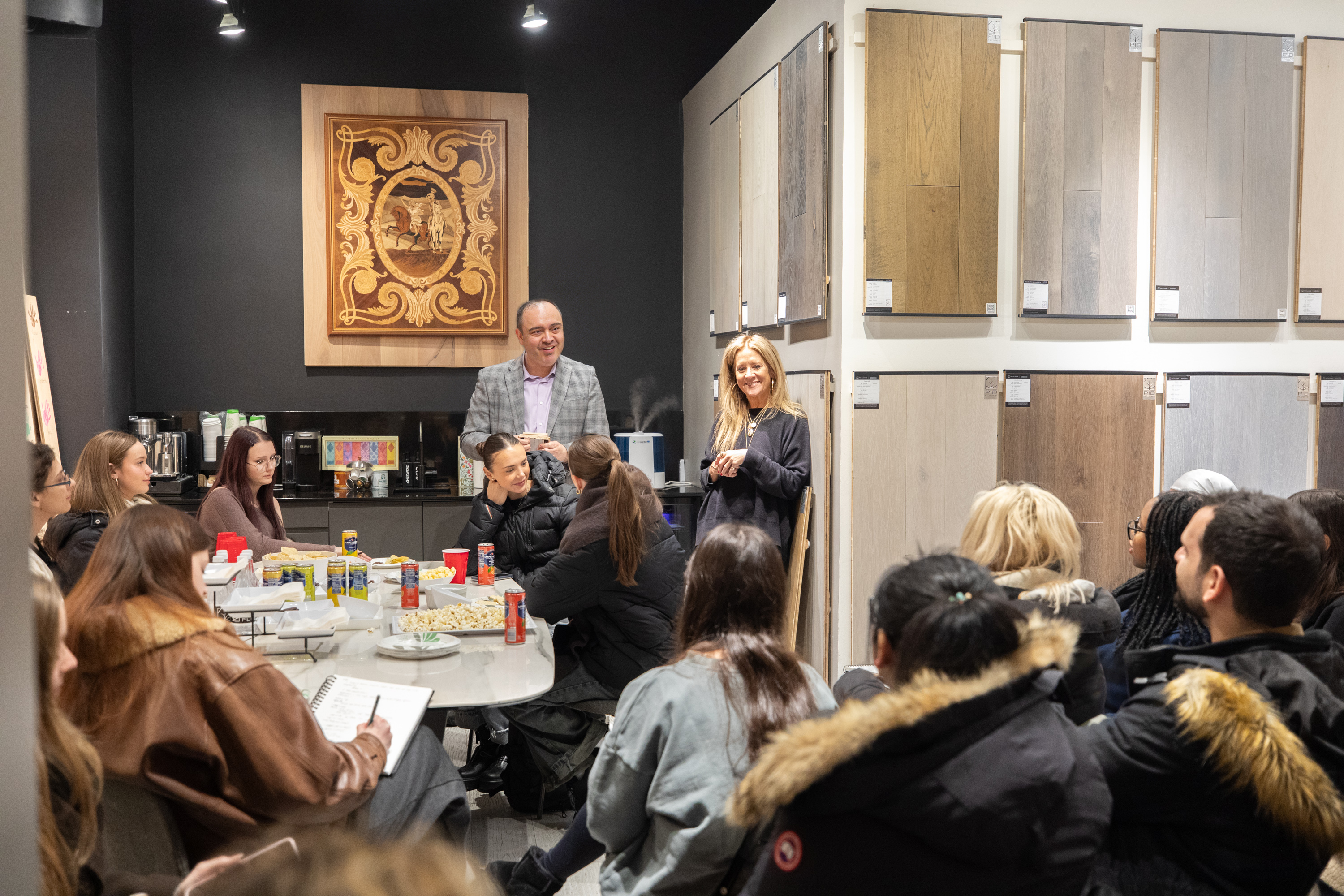PID Floors team member guiding FIT students through showroom's curated hardwood collections