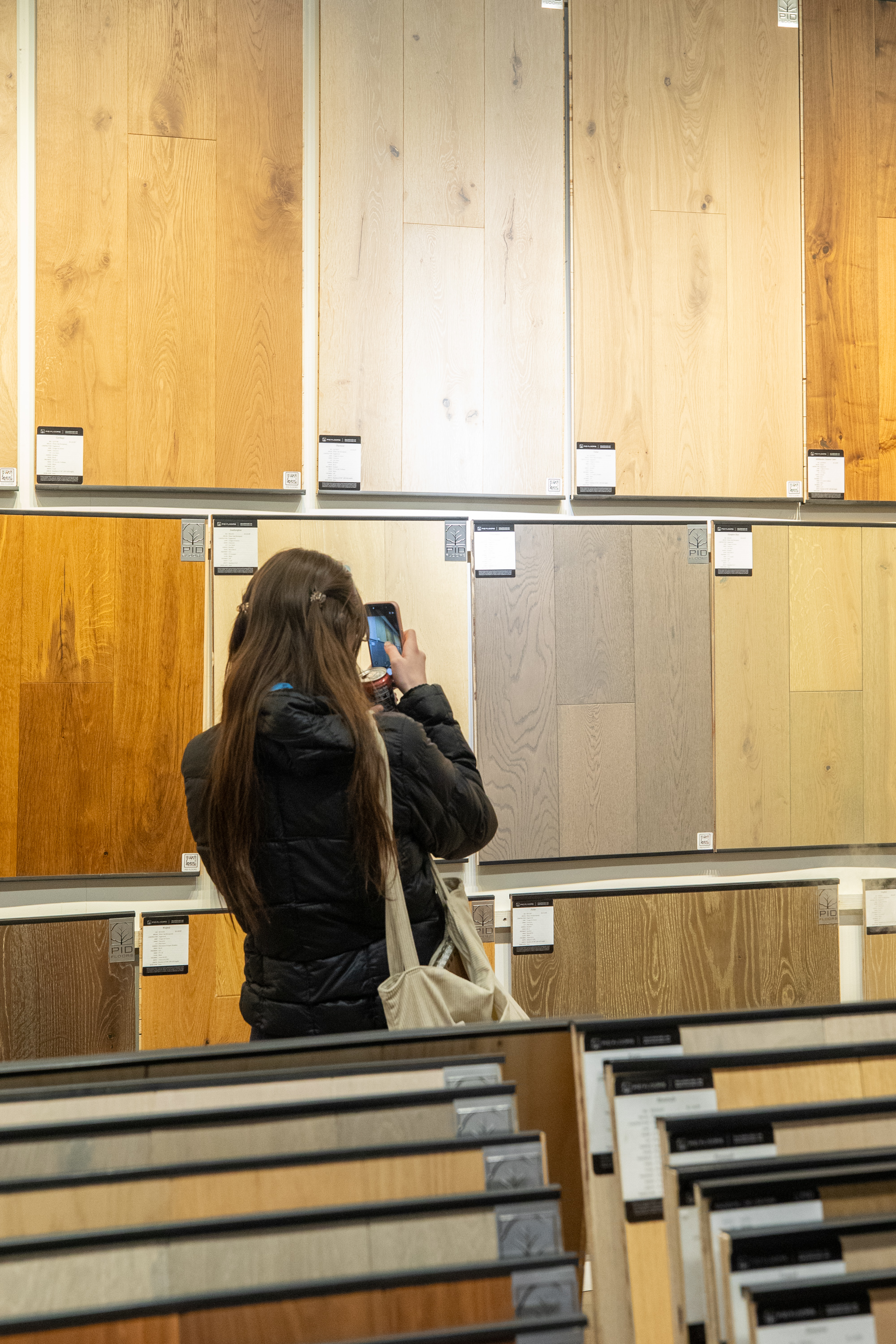 FIT design students taking photos of wood flooring installations in PID Floors showroom
