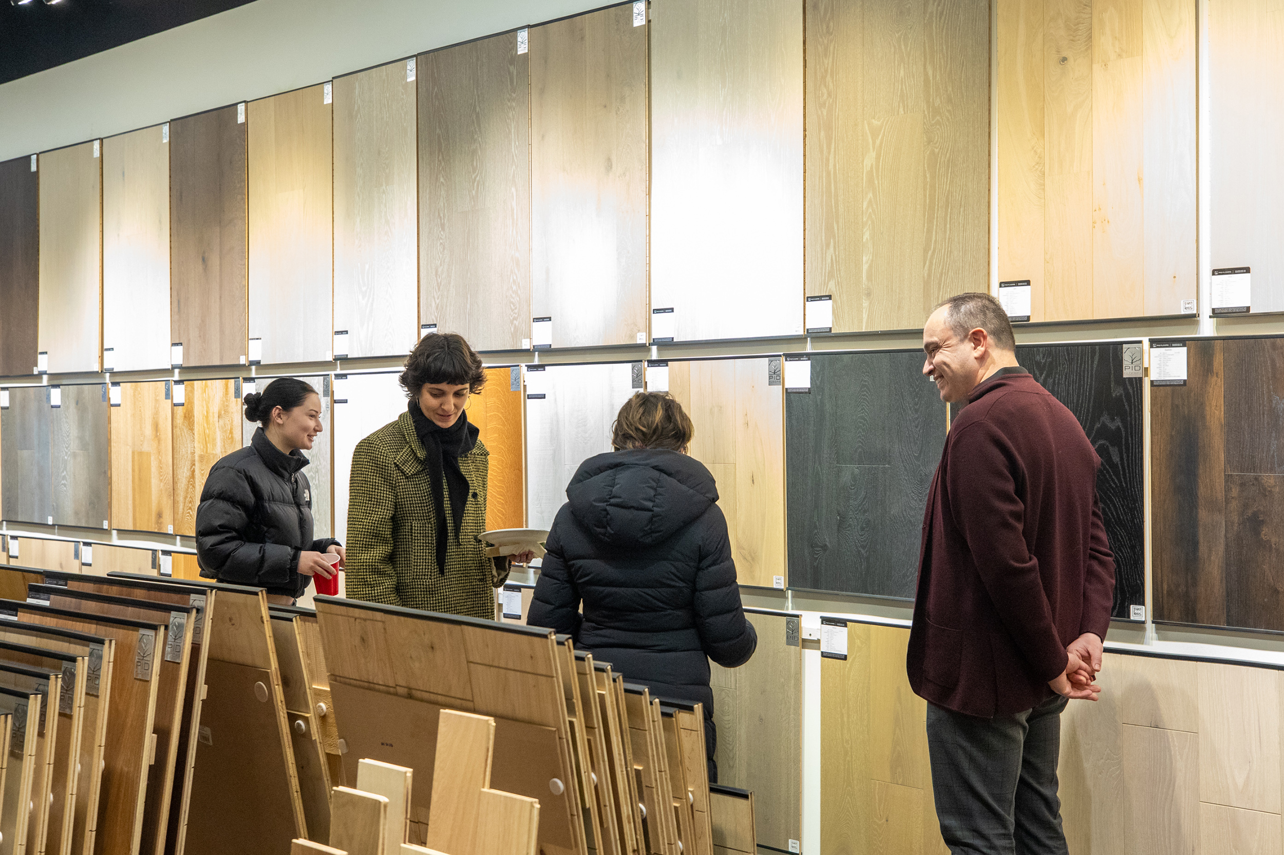 FIT students viewing hallway and entryway hardwood flooring displays at PID Floors NYC