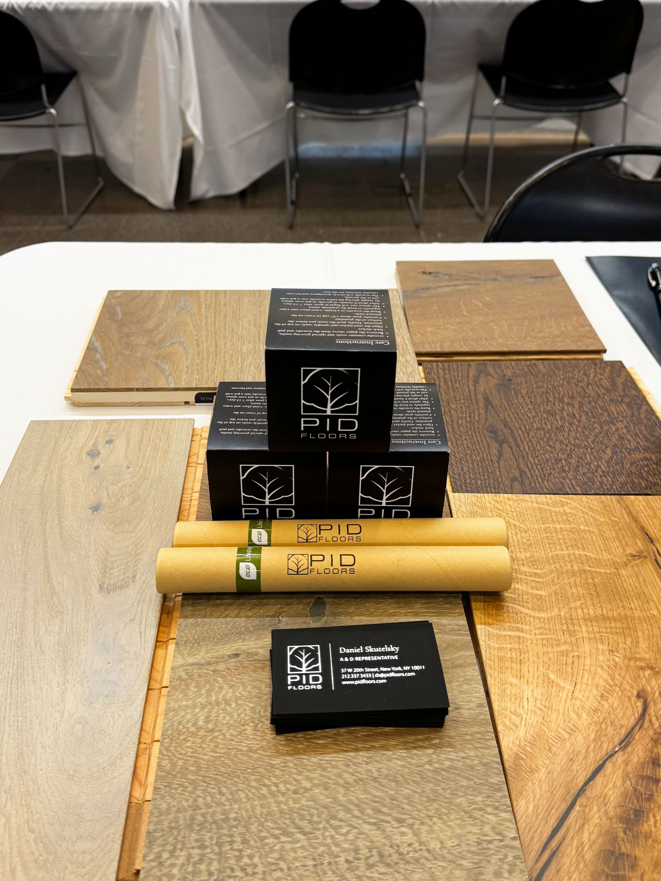 Premium hardwood flooring samples presented by PID Floors at FIT career fair showcasing sustainable wood species and custom finishes