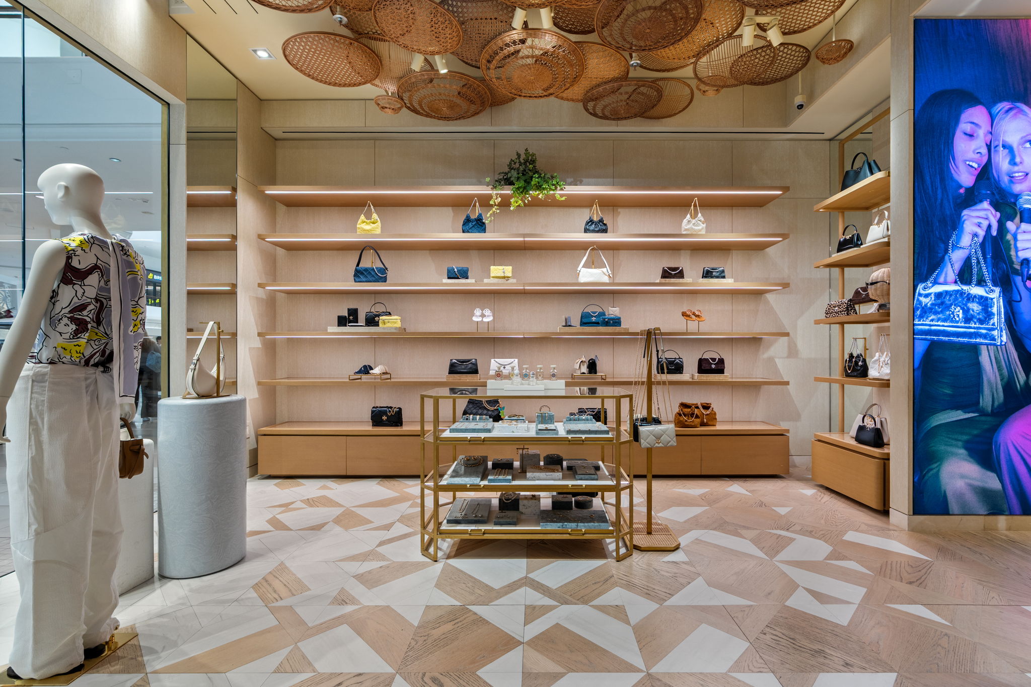 Wide-plank wood floors in warm tones installed at Tory Burch Aventura, Florida