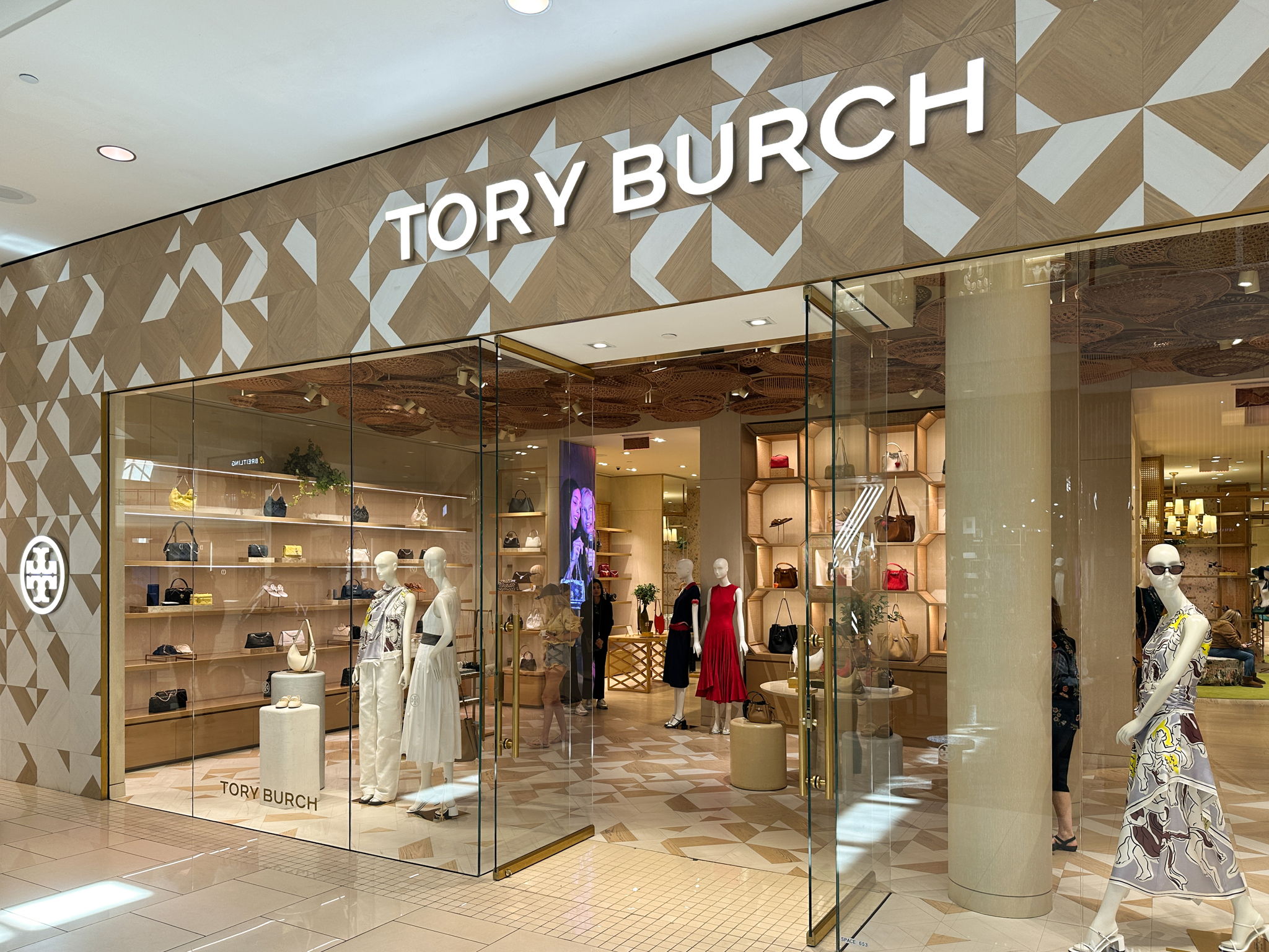 Refined boutique atmosphere at Tory Burch Aventura featuring PID hardwood floors