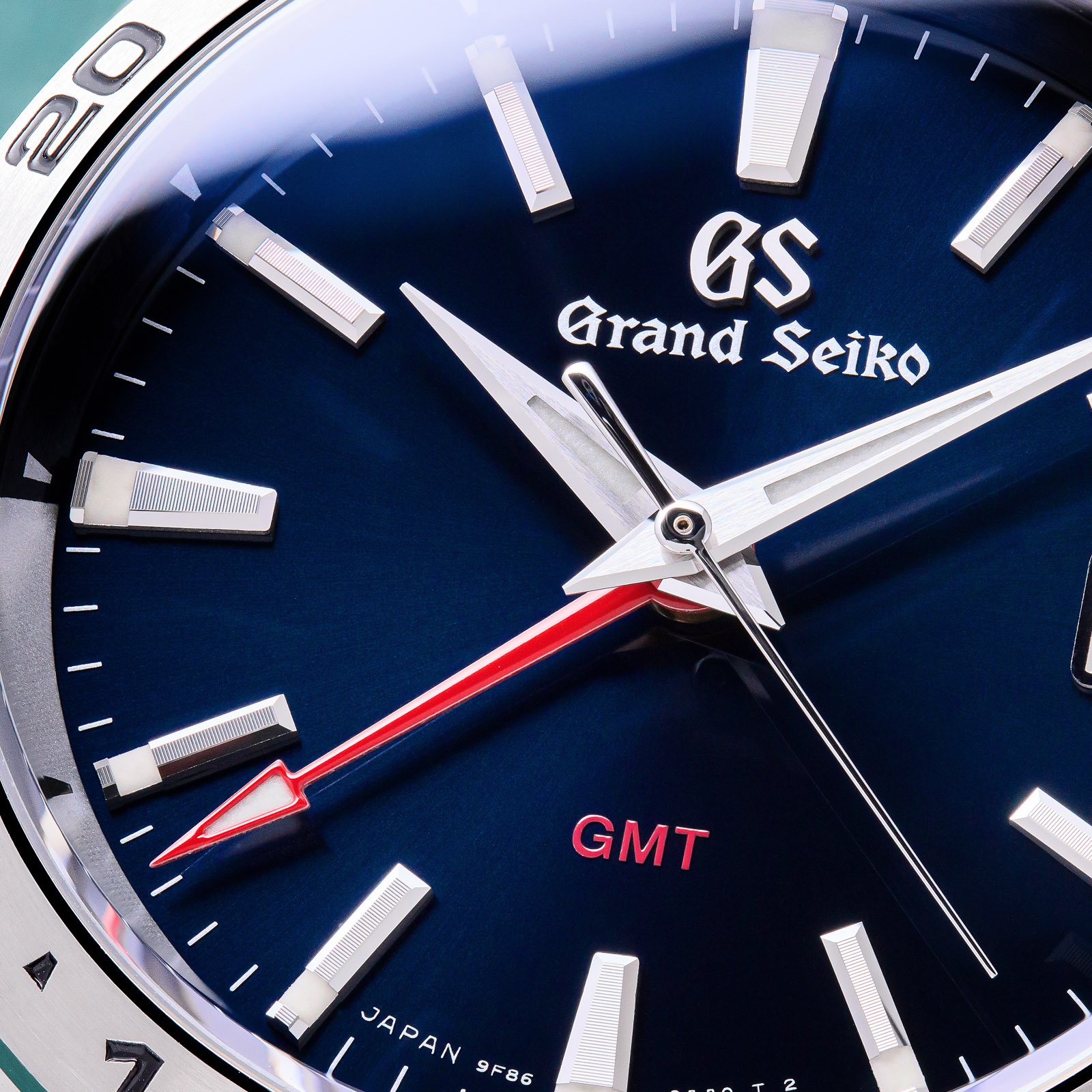 Grand Seiko SBGN005 - macro detail of blue dial with red accents. 