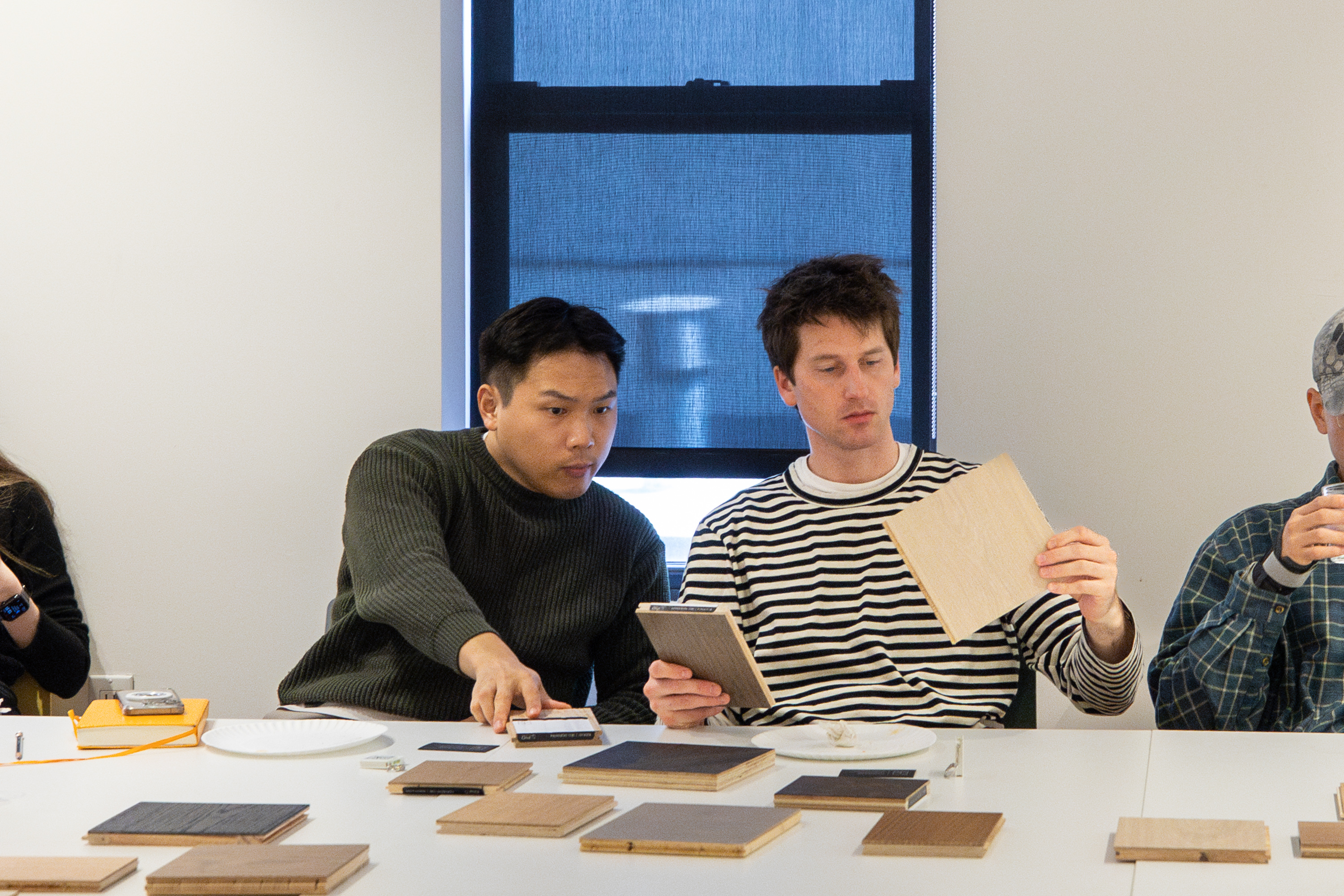 Attendees discussing flooring integration in design