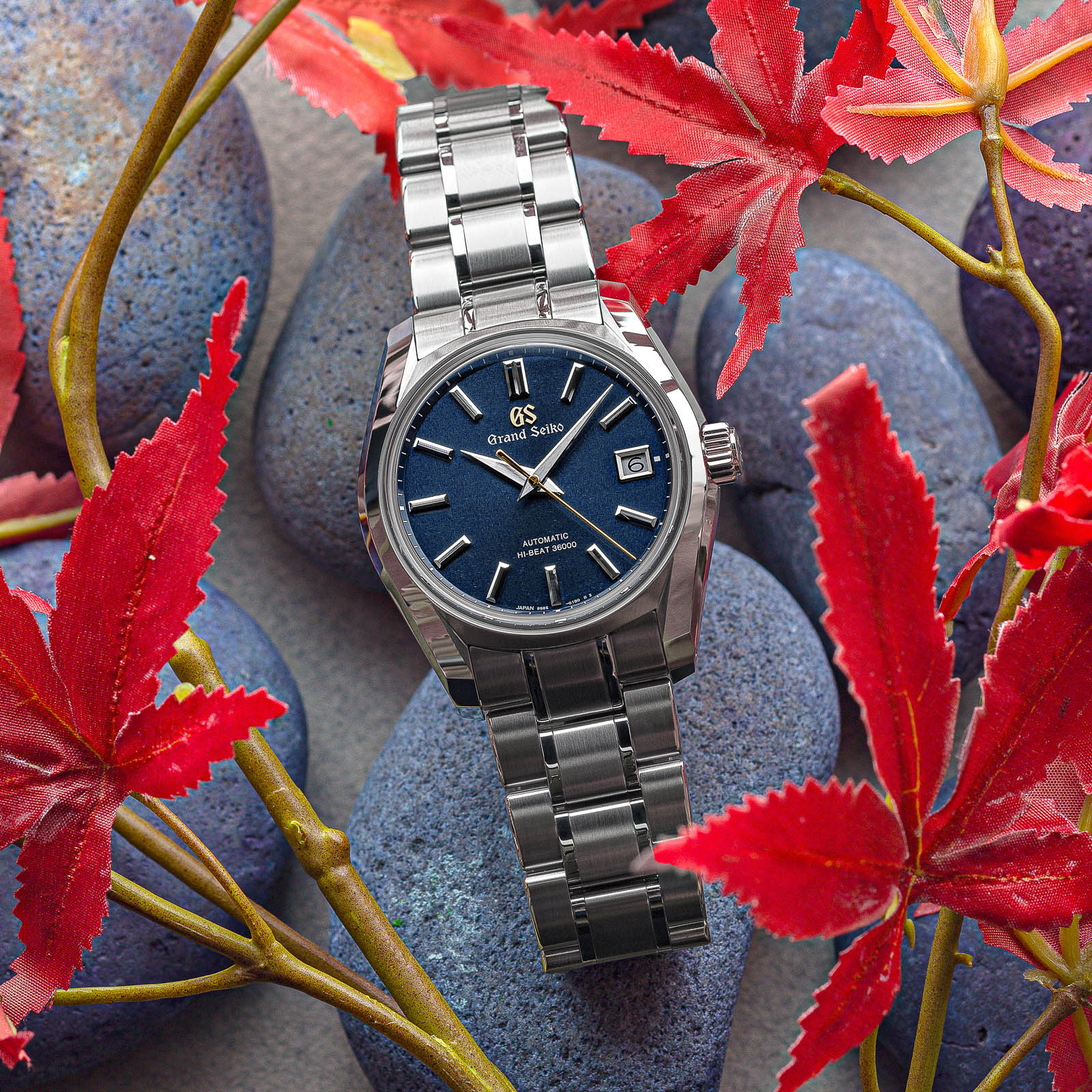 Stainless steel wristwatch with a blue textured dial. 