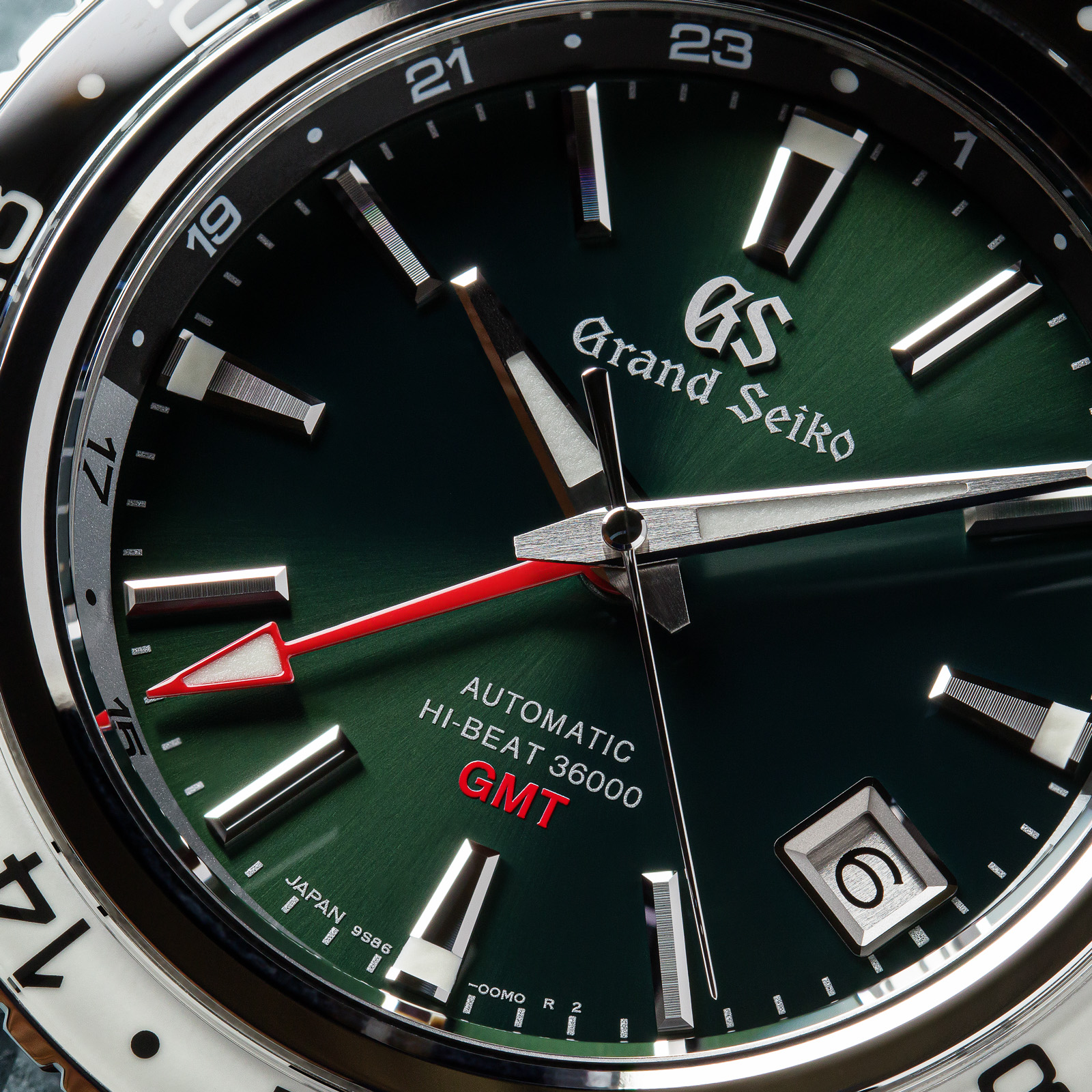 Grand Seiko SBGJ239 - macro detail of green dial with red accents. 