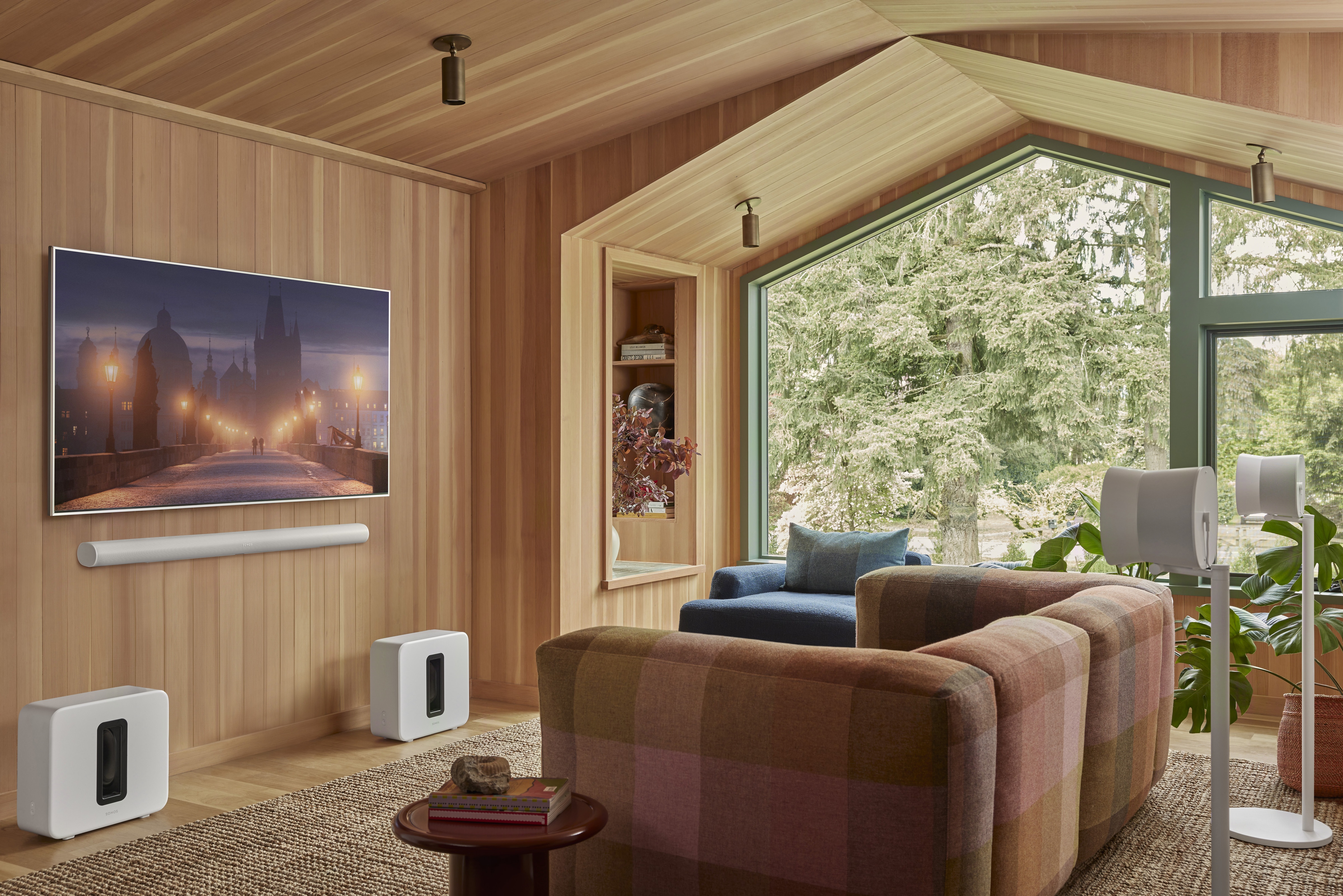 Sonos Arc Ultra soundbar with Sonos Sub and Era 300 surround speakers in a modern living room, creating an immersive Dolby Atmos home theatre setup.