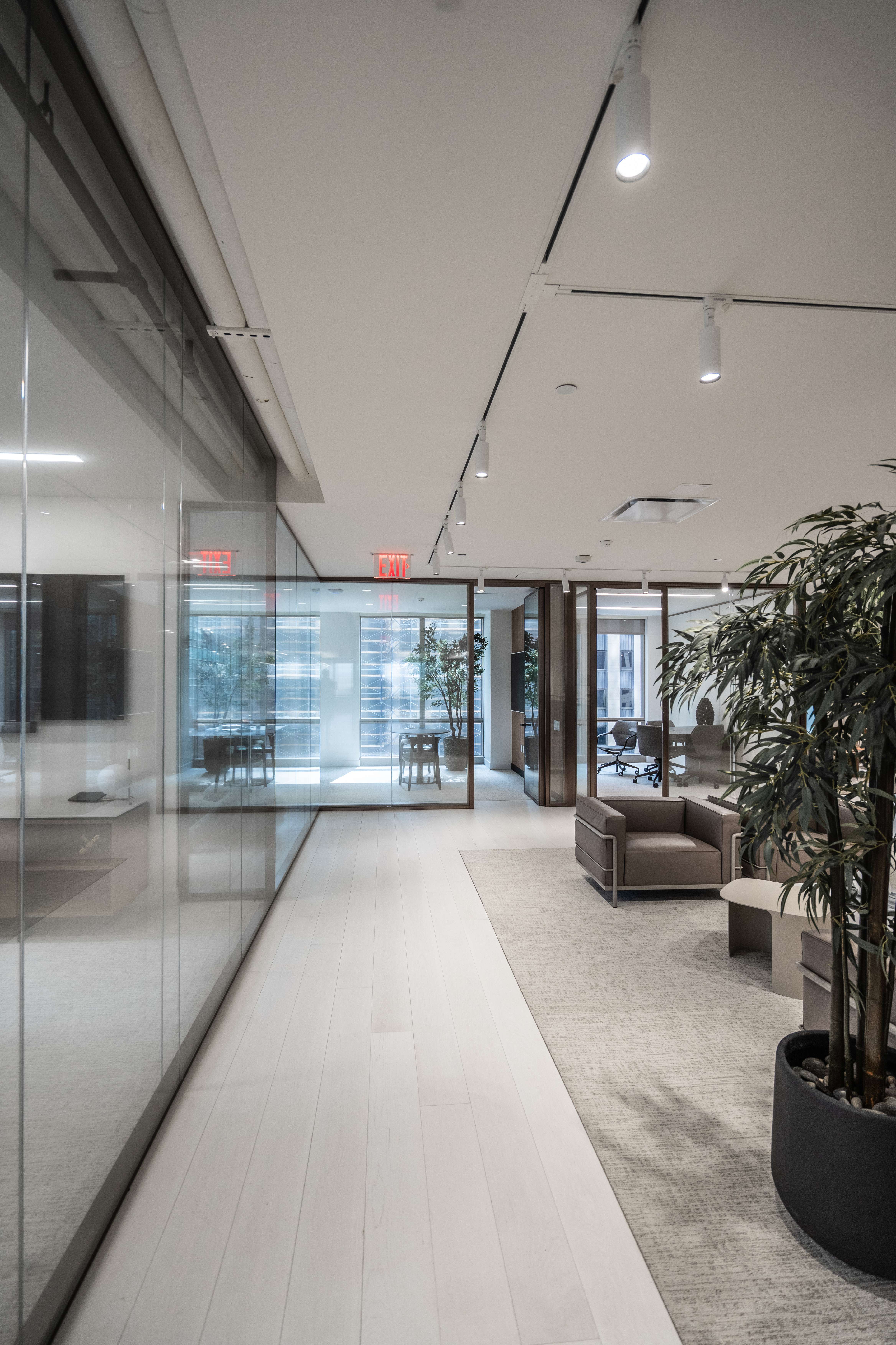 Elegant commercial flooring project with wide plank wood floors and open workspace design by PID Floors