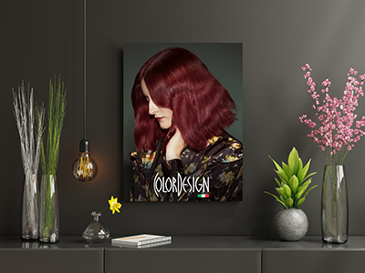 A poster of a woman with red hair looking down, there are flowers in vases on a table