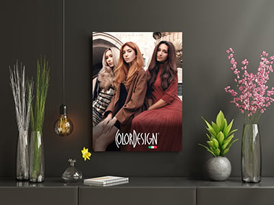 A poster of three woman with long hair looking at the camera, there are flowers in vases on a table