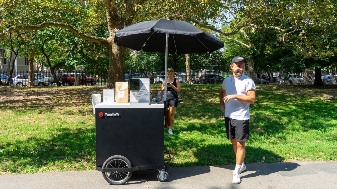 Lenni stands next to the TK Cart, ready for thirsty parkgoers! 