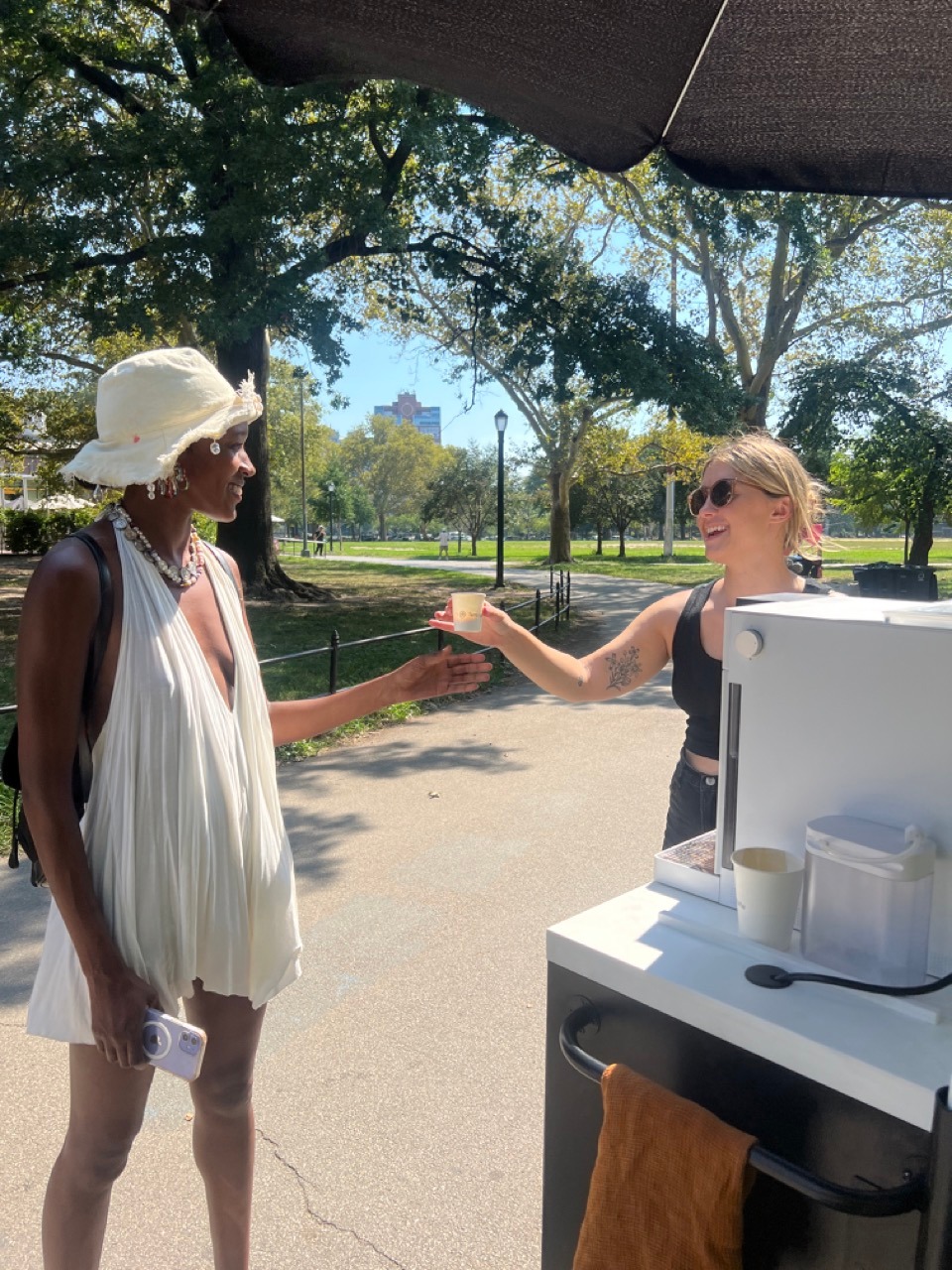 Delaney hands an espresso to a happy fan.