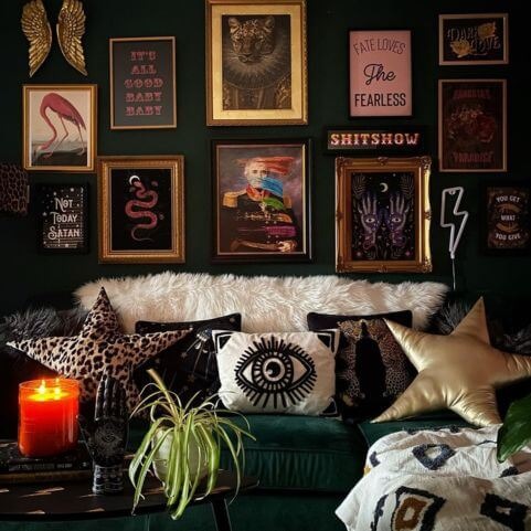 A maximalist living room with an abstract gothic design, including a gallery wall of maximalist art, star-shaped cushions and abstract designs.