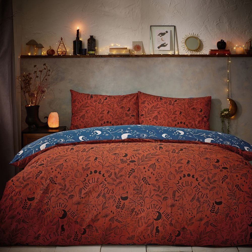 Orange and blue reversible bedding featuring a halloween print