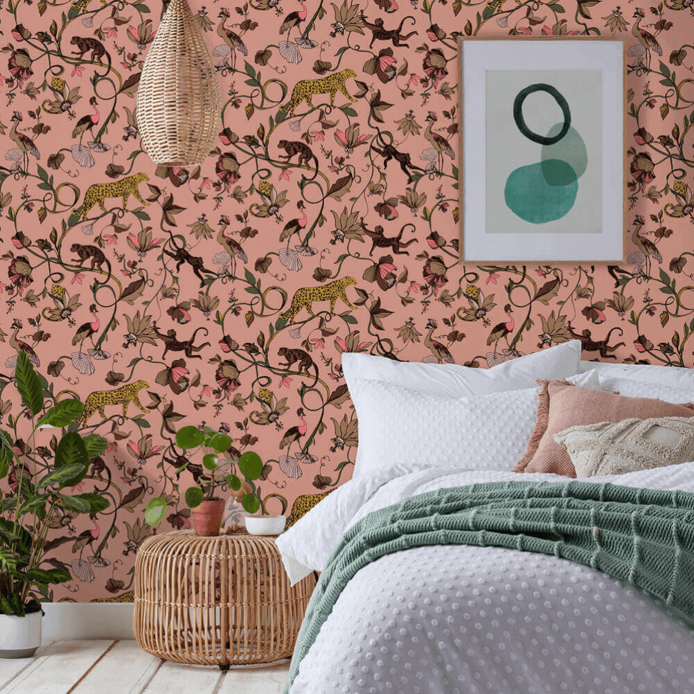 a romantic bedroom with a pink exotic pattern wallpaper feature wall, with monkeys and leopards and more. 