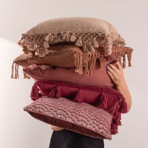 pile of cushions in different berry and beige colours