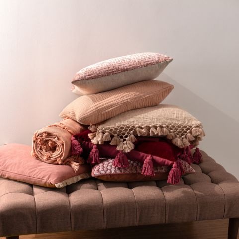 pile of cushions in different berry and beige colours