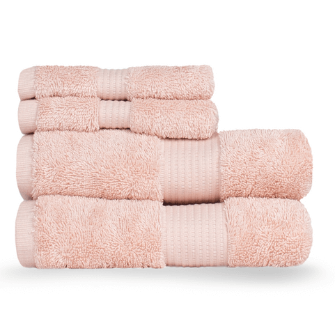 a stack of plump, neatly folded, blush pink Egyptian cotton towels.