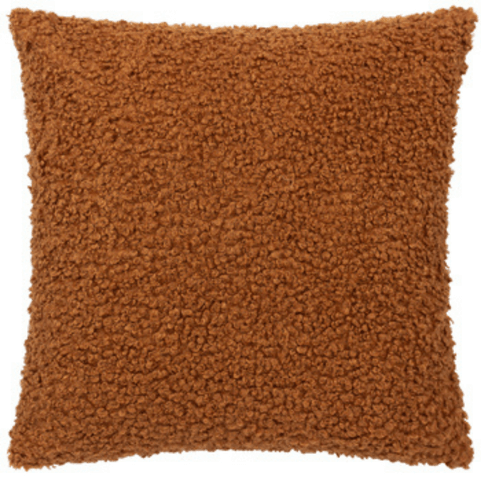 the front view of a Cabu cushion. it's made from boucle so it's textured, in an earthy ginger tone 