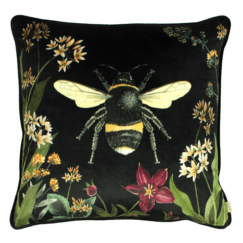 the midnight garden bee cushion, featuring a big bee in the centre, and botanicals around the outside. 