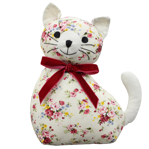 a cat doorstop created in ditsy floral fabric. it has a red velvet bow around its neck.