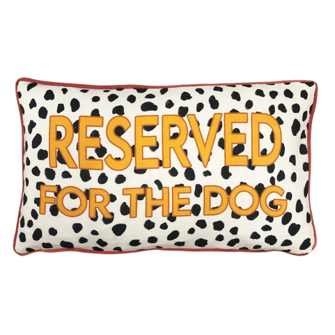 the woofers cushion front with black and white Dalmatian-like spots all over it and the words 'reserved for the dog' in yellow on top 