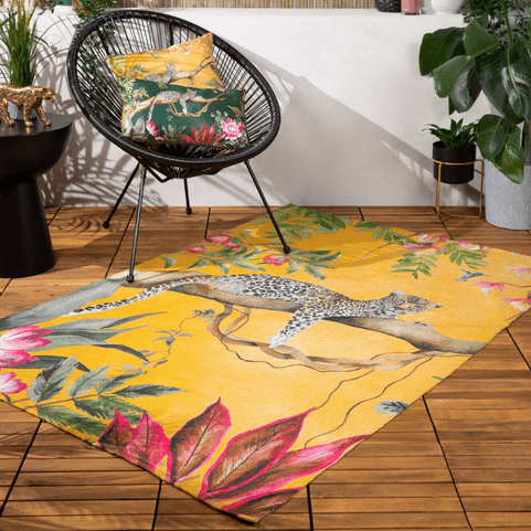 yellow leopard outdoor rug on wooden deck with chair on top