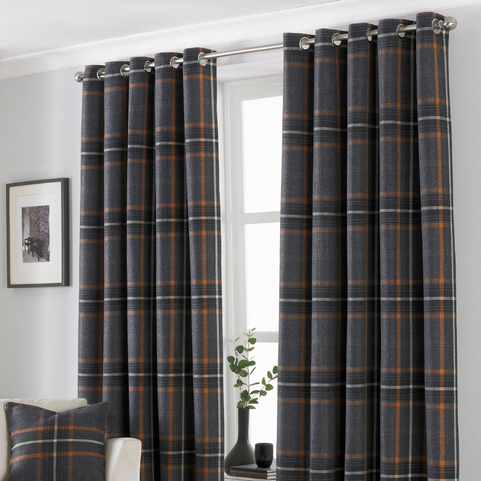 charcoal grey and rust coloured tartan faux wool eyelet curtains hanging in a neutral coloured living room.