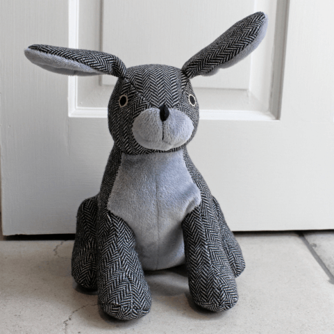 a two-toned grey sand-filled rabbit doorstop, designed with a charcoal herringbone weave and contrasting soft silver details.