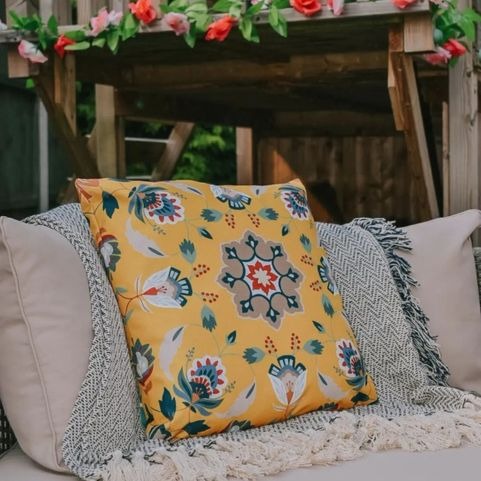 folk flora outdoor yellow cushion on sofa