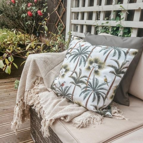 palm printed outdoor cushion on sofa