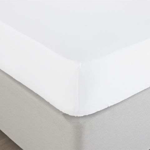 A closeup image of a white, 200 thread count, fitted bamboo bed sheet, fitted over a mattress on top of a grey fabric bedframe.