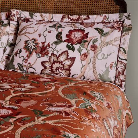 A red sateen pillowcase with an exotic floral design.