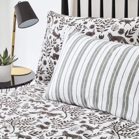 A brushed cotton duvet cover set with a black and white scandi-style woodland design.