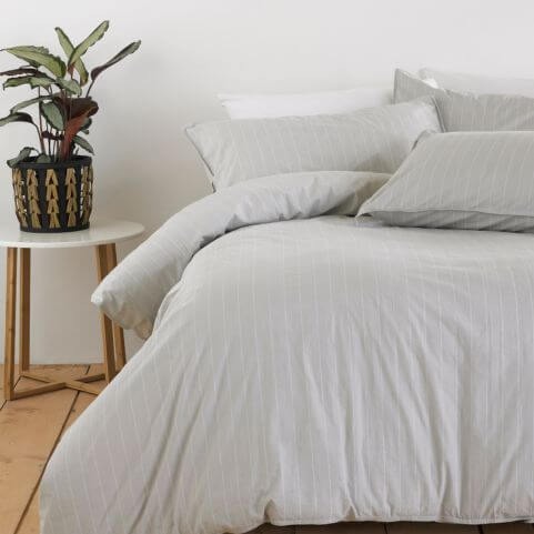 A grey washed cotton duvet cover set with a vertical pinstripe design.