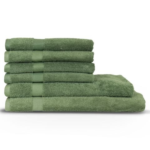 A collection of variously sized combed cotton towels in a eucalyptus green shade, folded and piled on top of one another in a bundle.