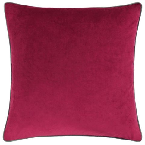 A plain velvet cushion in a cranberry red shade, complete with a contrasting piped trim in a mocha brown shade.