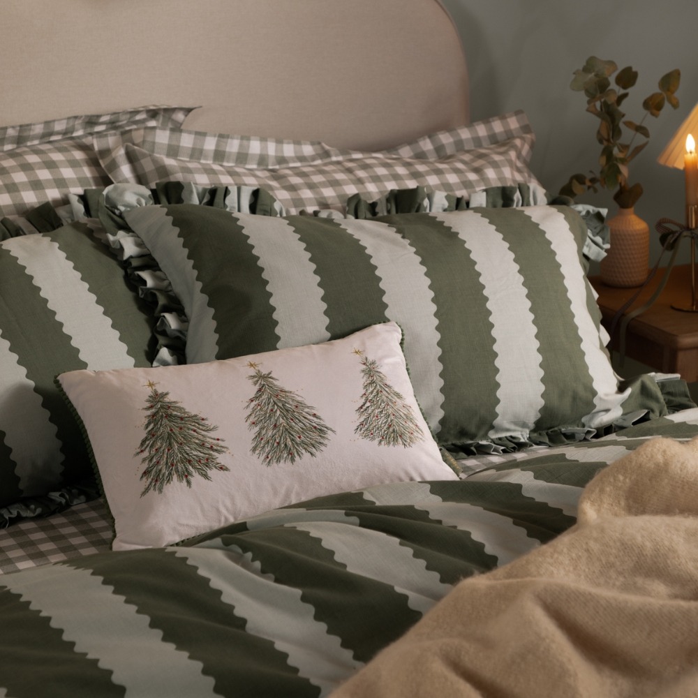 A green and blue wide stripe duvet cover set with frills on the edges with a Christmas tree rectangle cushion