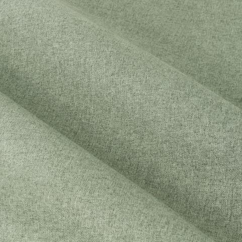 A closeup image of a blackout curtain panel fabric in a eucalyptus green shade.