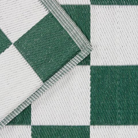 A closeup image of an outdoor rug made from 100% recycled polypropylene, with a green and white checkerboard design.