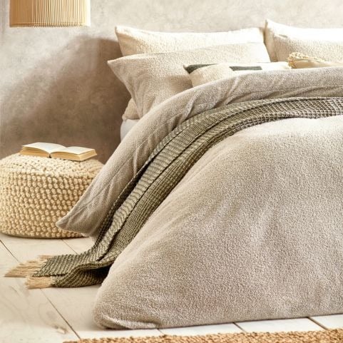 beige boucle bedding with minimalist decor