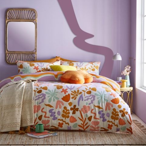 patterned bedroom with purple wall and colourful maximalist bedding