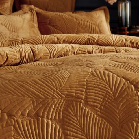 gold quilted velvet duvet set on bed