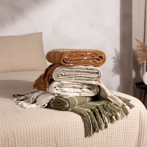 pile of throws in neutral colours