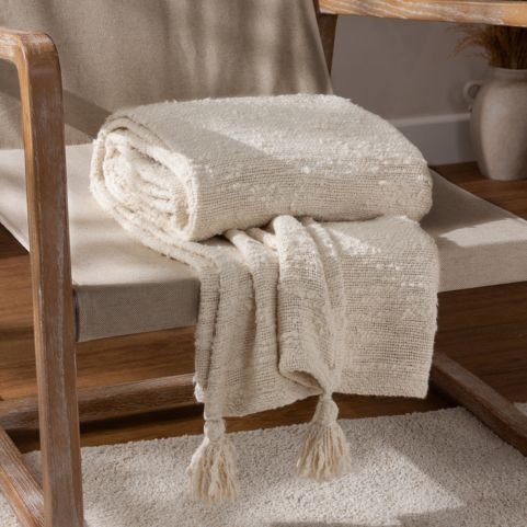 white throw on wooden chair