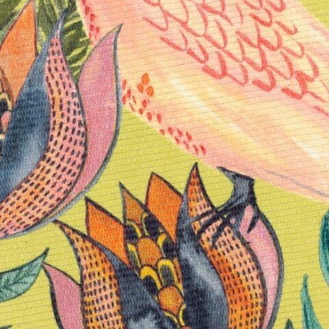 A closeup image of an indoor/outdoor polyester rug with a printed cockatoo design in yellow, orange and pink shades.
