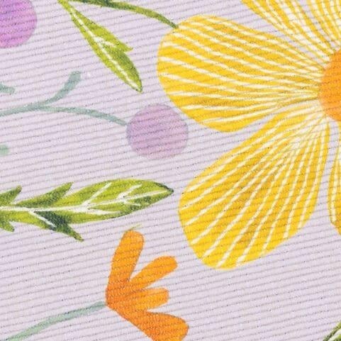 A closeup image of an indoor/outdoor rug polyester rug with a yellow, green and orange floral design on a lilac background.