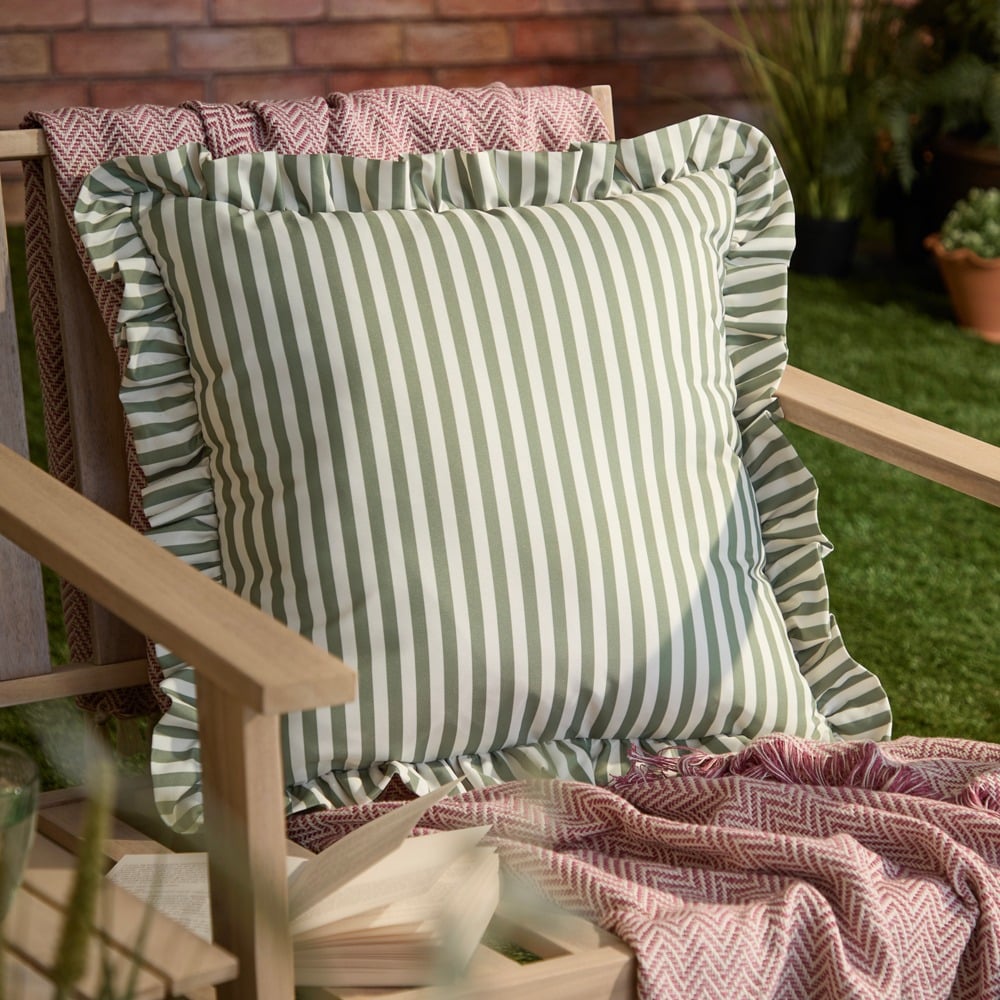 A green striped ruffle edge outdoor cushion