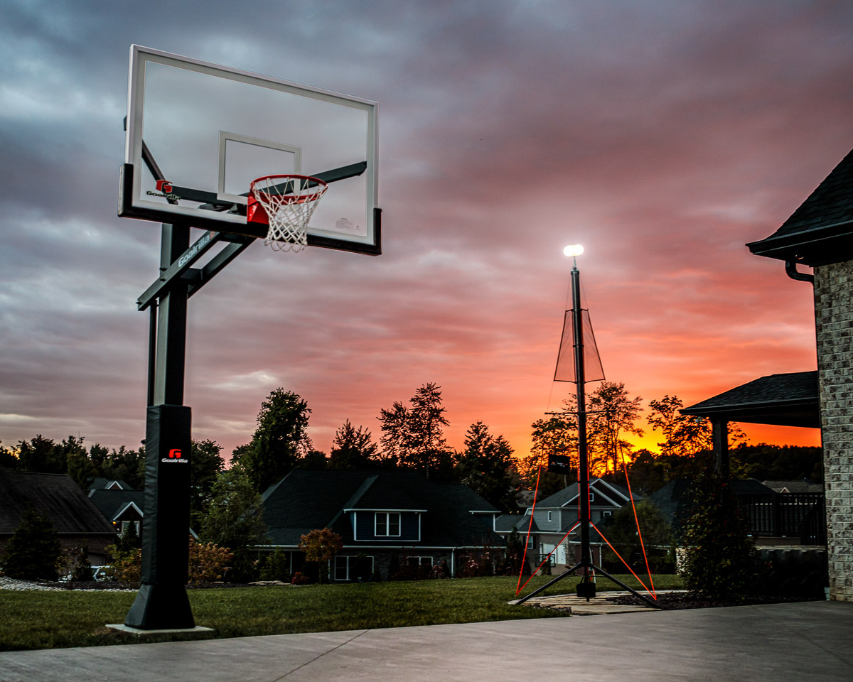 Goalrilla in the ground basketball goal in the driveway with basketball court light